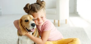 girl hugging dog